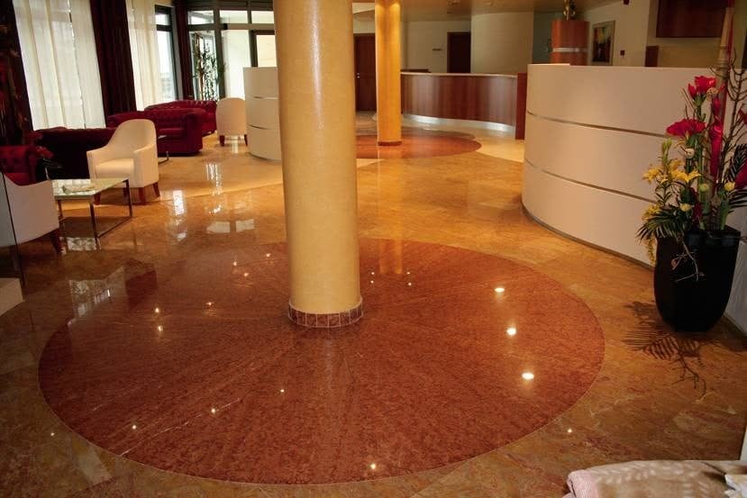 Pardoseală lucioasă din marmură Rosso Verona într-o zonă de recepție modernă